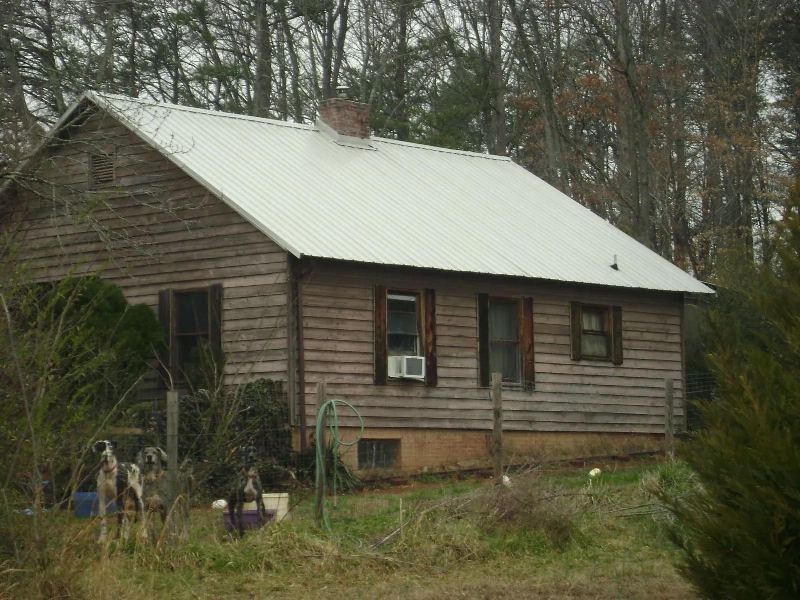 White metal roof on an old wood sided farmhouse, from a Metal Roof Installation job in Tekoa